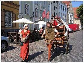 юноша с повозкой по узким улочкам Таллина