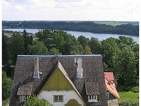 красивое архитектурное здание на фоне леса и реки в Эстонии