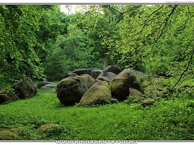 необычные каменные глыбы, обточенные водой на лесной поляне Софиевского парка
