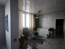 белая мягкая мебель, бирюзовый стеклянный журнальный столик на коврике, стилизованном под шкуру зебры у окна с белыми вертикальными жалюзи гостиной современной квартиры