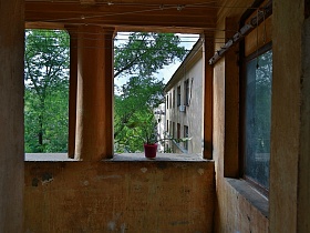 натянутые веревки для сушки белья  на открытом балконе коммунального общежития