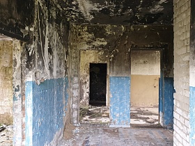 голубые и бежевые панели различных комнат с грязным черным потолком старого полуразрушенного здания заброшенного лагеря на берегу водохранилища
