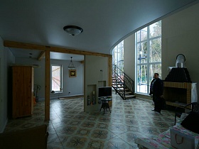 бежево-коричневая плитка на полу просторного зонированного холла с высокими окнами недостроенного элитного дома
