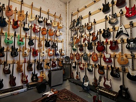 разноцветные гитары разных направлений музыки - джаз, рок, блюз в музыкальном стильном магазине на территории отдельного здания