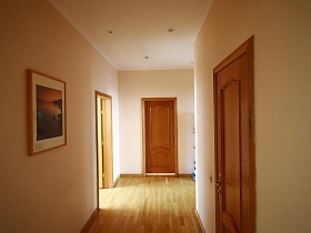 одинаковые светло-коричневые двери в разные комнаты из светлого коридора большой стандартной семейной квартиры на втором этаже жилого дома в Марьино
