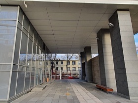 Большая квадратная арка ведущая в современный двор бизнес класса