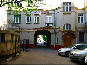 арочный навес над входной дверью и окно подъеза в углу дома у арочного перехода во дворе на Долгоруковской