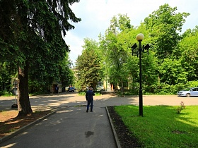 ровные асфальтированные  дорожки зеленых аллей на ухоженной территории усадьбы времен СССР
