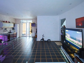 картина в красном цвете над телевизором в гостиной креативного дома