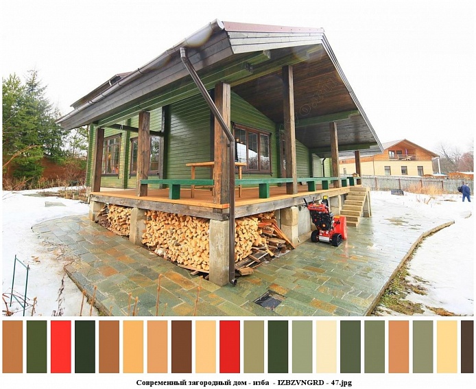треугольная крыша со стоком для воды зеленого деревянного дома с поленьями дров под полом открытой террасы