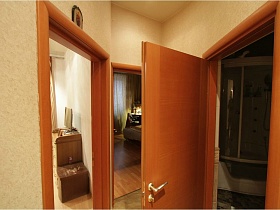 белый душевой бокс в ванной комнате сквозь открытую дверь светлой прихожей современной протой просторной квартиры Север 2 с детской