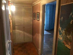 бра, картины на стенах коридора со встроенным белым шкафом и линолеумом на полу с шахматным рисунком кв 27