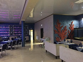 отдельные зоны для отдыха ресторана в синих цветах с подсветкой на синих стенах и натяжным потолком