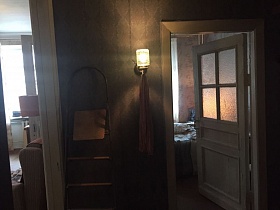 стеклянный плафон бра на серой стене коридора, лестница стремянка между открытыми дверьми в разные комнаты кв.24