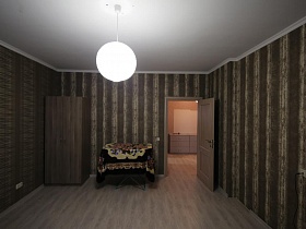 полосатые стены в коричнево-бежевых тонах зала в большой квартире с евро ремонтом