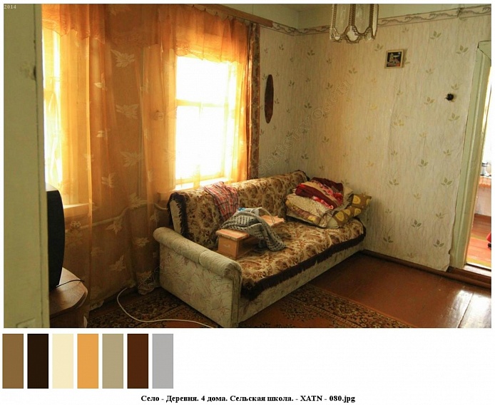 ковровое покрытие на светлом мягком диване с постельными принадлежностями в углу комнаты со светлыми обоями и желтыми гардинами на окнах сельского дома