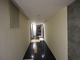 входные двери жилых квартир в светлом коридоре на этаже современного многоэтажного дома новостроек