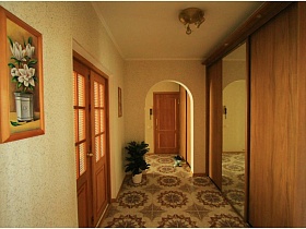 картина с белыми цветами на стене и шкаф-купе с зеркалом по центру в светлом коридоре трехкомнатной квартиры панельного дома